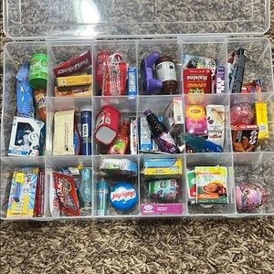 Collection of various mini brands in container